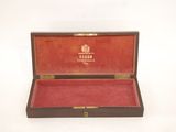 a wooden box with a red velvet lining inside