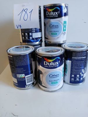 five cans of duluxx paint on a table