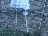 two umbrellas that are on the ground near a stone wall