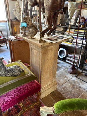 a statue of a horse on a pedestal in the middle of a room