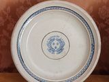 a white plate with blue flowers on it on a wooden table