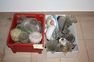 a red box filled with assorted items sitting on the floor