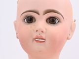 a close up of a doll ' s face with a white background