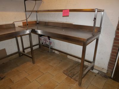a picture of a kitchen area with a table and two benches