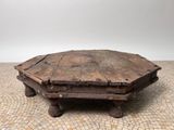 an old wooden coffee table with a stone top on a tiled floor