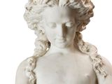 marble statue of a young boy holding a bowl of fruit