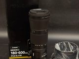 a camera lens sitting on a table next to a box
