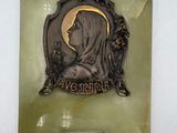 statue of a woman with a veil on a plaque mounted on a wall