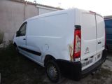 a white van that is parked next to a blue van