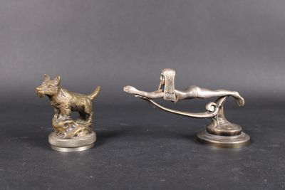 pair of silver figurines of a dog and a man on a swing