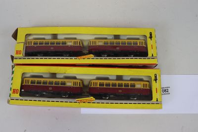 deux wagons rouges et jaunes exposés dans une boîte