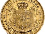 a close up of a gold coin with a coat of arms on it
