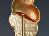 a gold leaf pendant hanging from a wire on a wire
