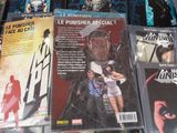 a lot of comic books on display on a table