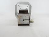 a small metal box with a handle on top of it