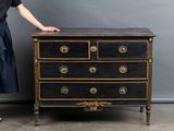 a woman that is standing next to a dresser