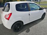 a small white car that is parked in the parking lot