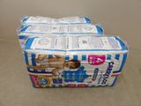 four packs of diapers stacked on top of each other