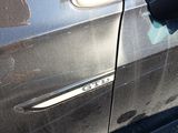 a black car that has a broken door handle on it
