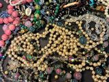 a lot of beads and necklaces on a table