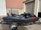 a black jet ski on a trailer in front of a building