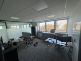 a room with a lot of chairs and a desk in it