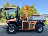 a picture of a small tractor with a backhoe on it