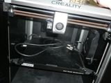 a person that is opening up a machine with wires in it