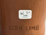 a close up of a clay pot with a sticker on it
