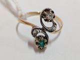 a gold ring with a green stone in it
