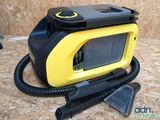 a yellow and black device sitting on top of a wooden floor