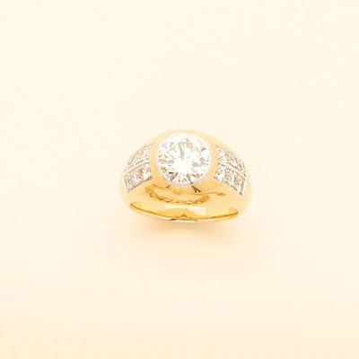 a close up of a gold ring with a diamond on it