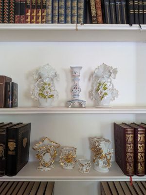 many books and vases on the shelves in the room
