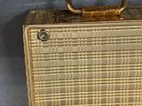 a gold suitcase with a handle on a blue background