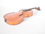an old violin sitting on a white surface with a white background