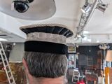 a man that is wearing a hat in a room