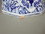 a blue and white vase sitting on a table