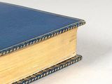 a blue book sitting on top of a white table