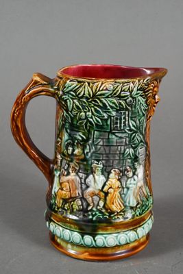 a ceramic pitcher with a painting on it on a table
