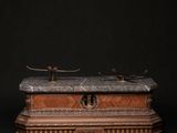 a wooden box with a marble top sitting on a table