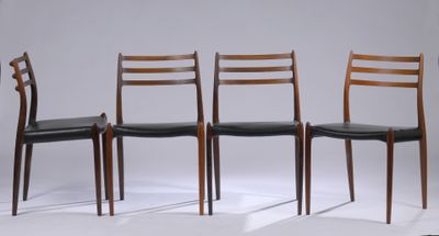 four chairs are lined up in a row on a white surface