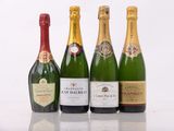 four bottles of champagne are lined up in a row