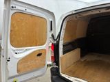 a white van with the door open in a garage