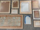 a lot of framed and unframed pictures on the floor