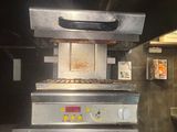 a stove that is sitting in the middle of a kitchen