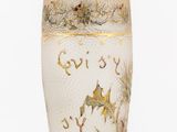 a white vase with gold and blue designs on it