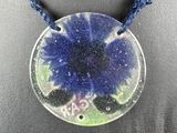 a close up of a necklace on a mannequin with a blue flower on it