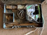 a suitcase with tools inside of it on the floor