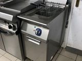 a kitchen with a stove, oven, and sink in it