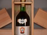 a bottle of wine in a wooden box on a table